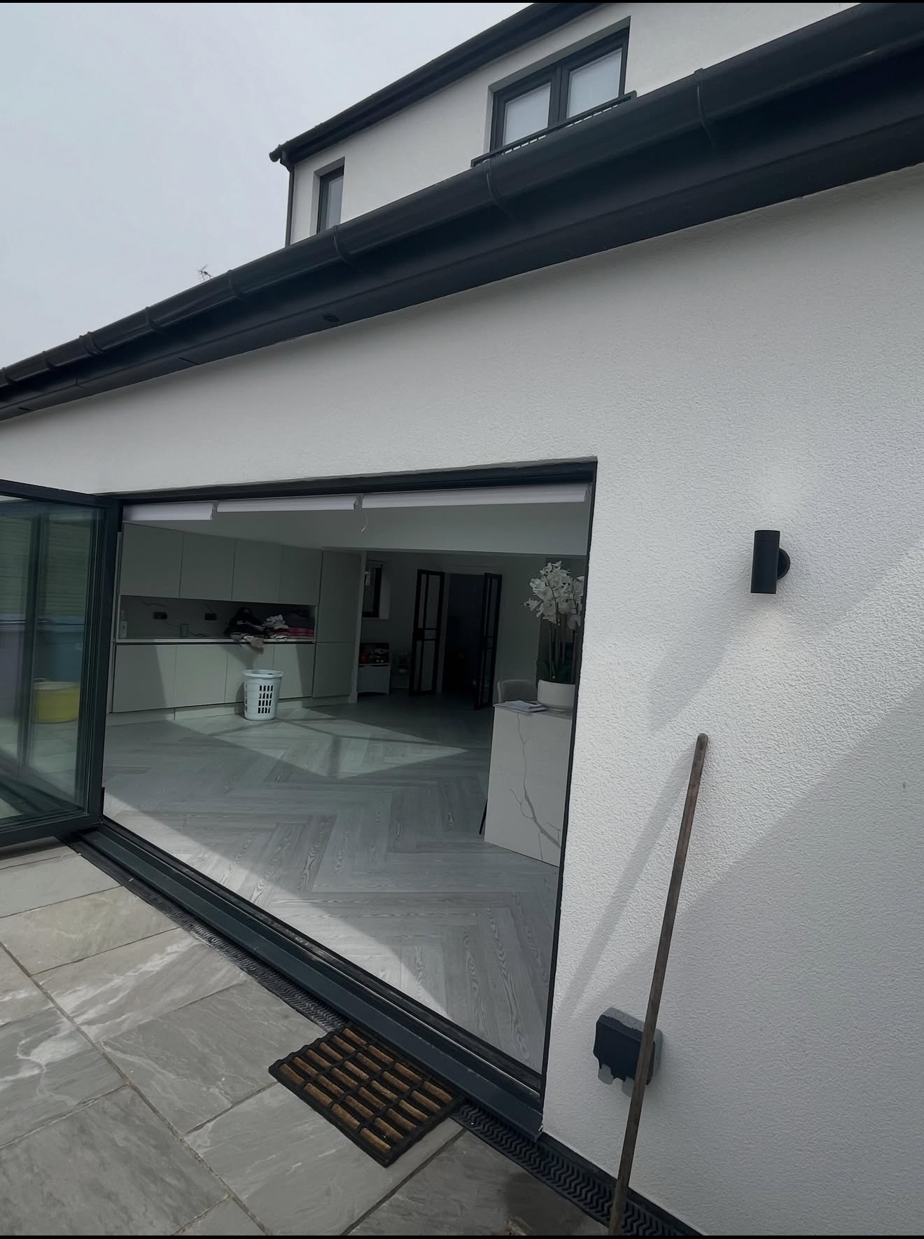 Rendered wall beside open bi-fold doors