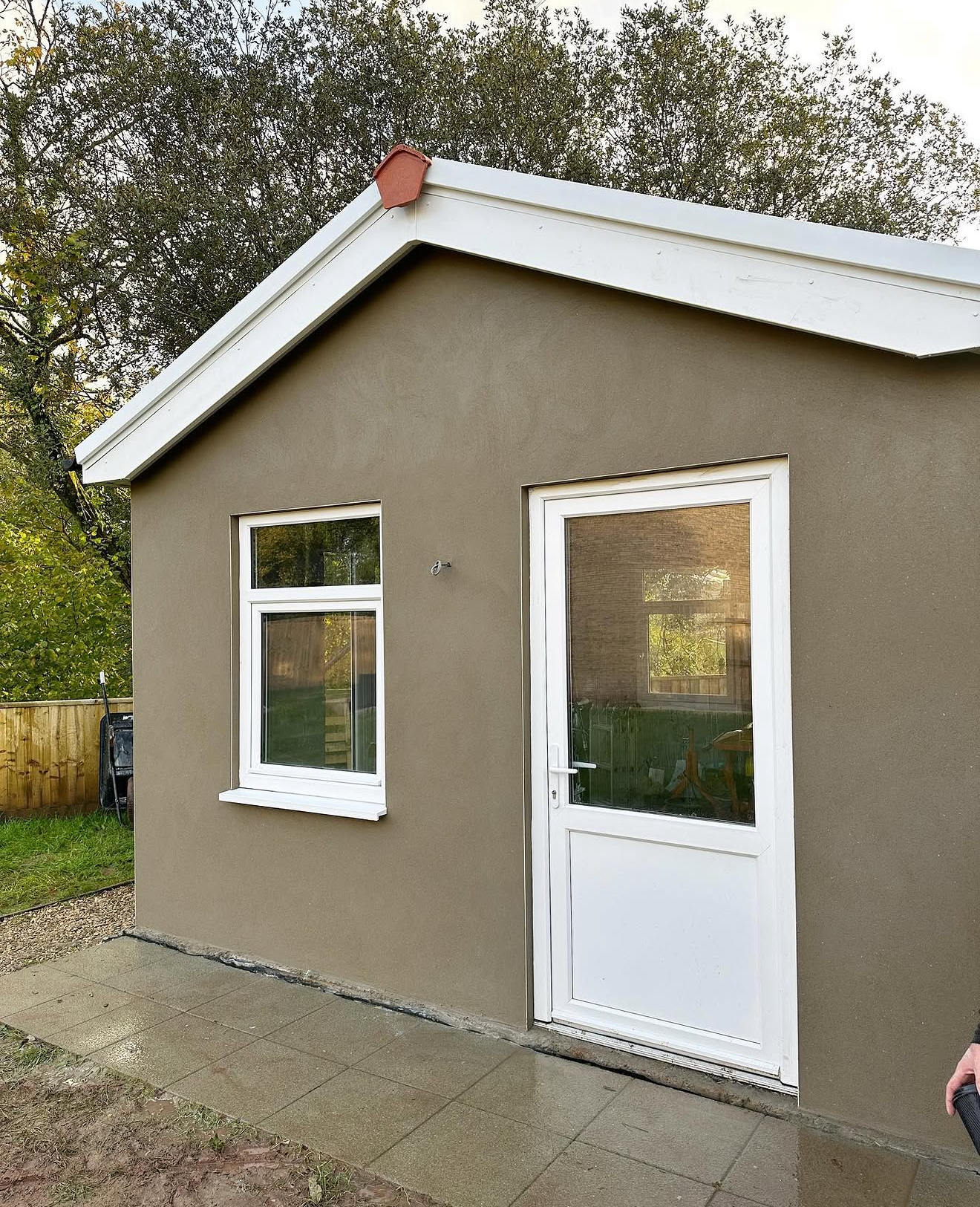 Rendered garden room with a white door