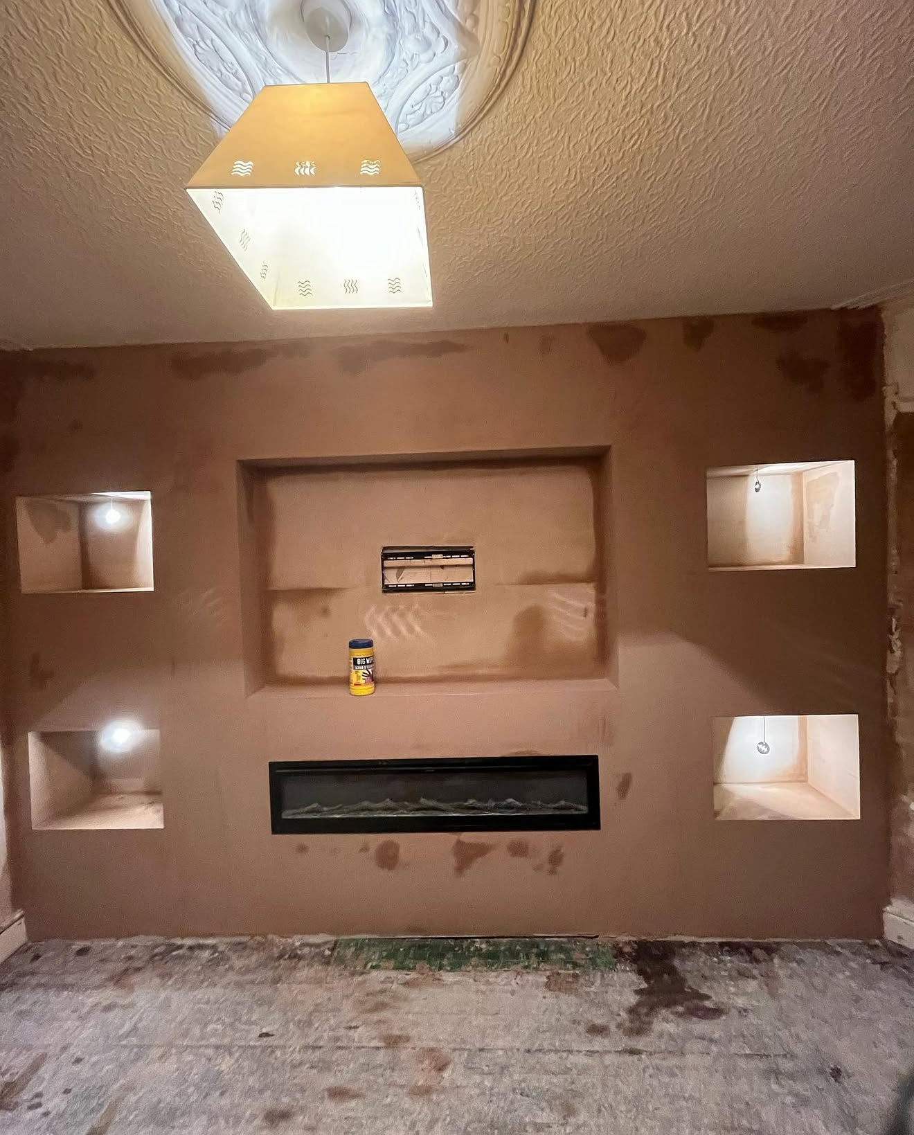 Plastered media wall with lit alcoves
