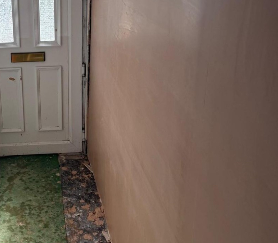 Plastered hallway wall by the front door